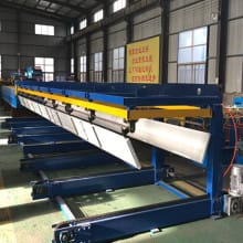 Automatic sheet stacker for roll forming machine